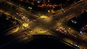 Aerial view of city road intersections at night. Real time video.