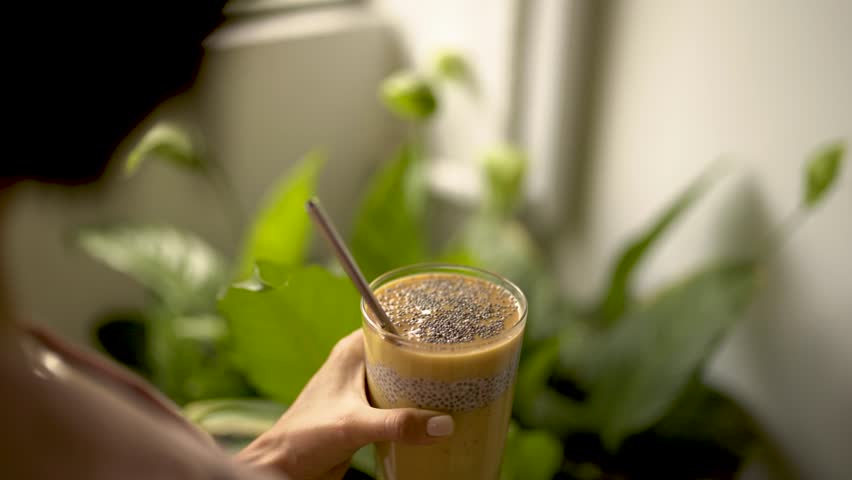 Smoothie papaya,mango, chia seeds, vegan, vegeterian, raw, leaf background