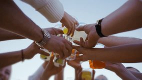 Low angle view of friends clinking glasses with colorful cocktails. People toast drinking  - Powered by Shutterstock - Get 15% off with code: PIKWIZARD15