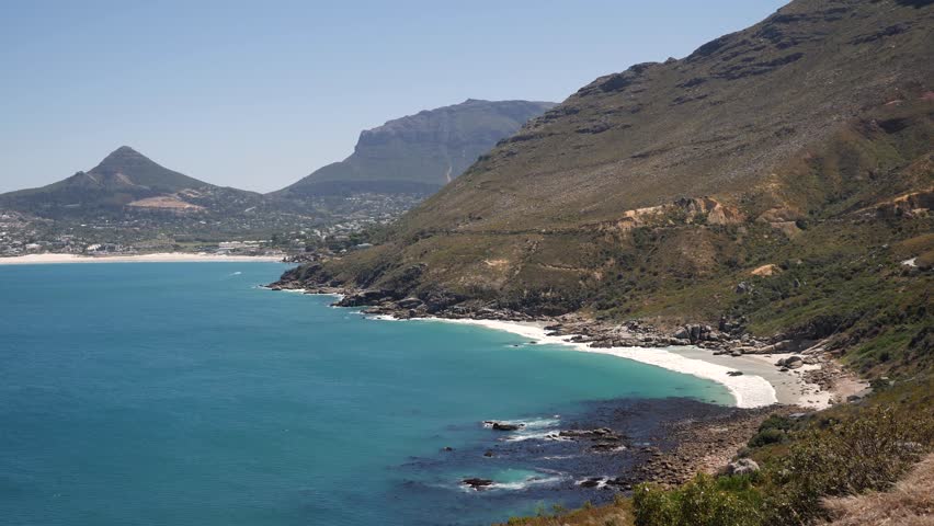4K footage of nature around Cape Town, South Africa. Rocky cliffs and Turquoise clean water with white sand beach in Cape Peninsula. Cape Point Nature Reserve with specific fauna and flora.