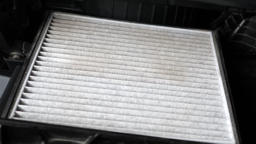 Closeup of old and dirty car air filter with dust in car. Concept of car care service maintenance and health. | Shutterstock HD Video #1104504439