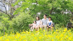 4K Happy Asian family parent and little kids enjoy and fun outdoor lifestyle on summer holiday vacation. Father, mother and child playing and resting together at park. Family relationship concept. - Powered by Shutterstock - Get 15% off with code: PIKWIZARD15