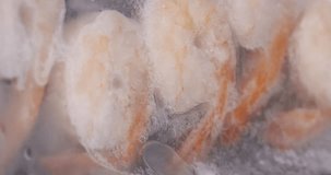 4K footage vertical video Time-lapse Close-up, Frozen prawns in the package are thawing.