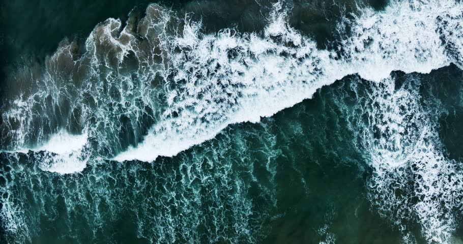 Aerial view shot Beautiful texture of big power dark ocean waves crashing in the ocean,Aerial top view footage of open sea in stormy day, Drone filming breaking surf with white foam in andaman ocean Royalty-Free Stock Footage #1104505505