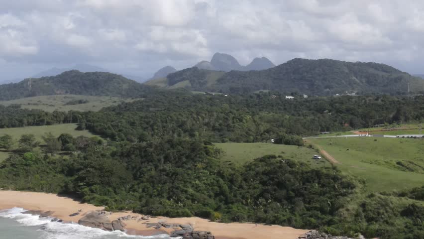 Drone-captured collection vividly showcasing Rio das Ostras' untouched beaches, bordered by majestic mountains, vibrant green farmlands, and meandering rivers, under an azure sky. Rio de Janeiro. Ocea