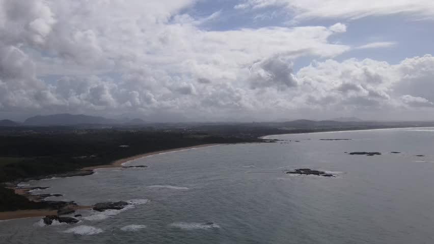 Drone-captured collection vividly showcasing Rio das Ostras' untouched beaches, bordered by majestic mountains, vibrant green farmlands, and meandering rivers, under an azure sky. Rio de Janeiro. Ocea