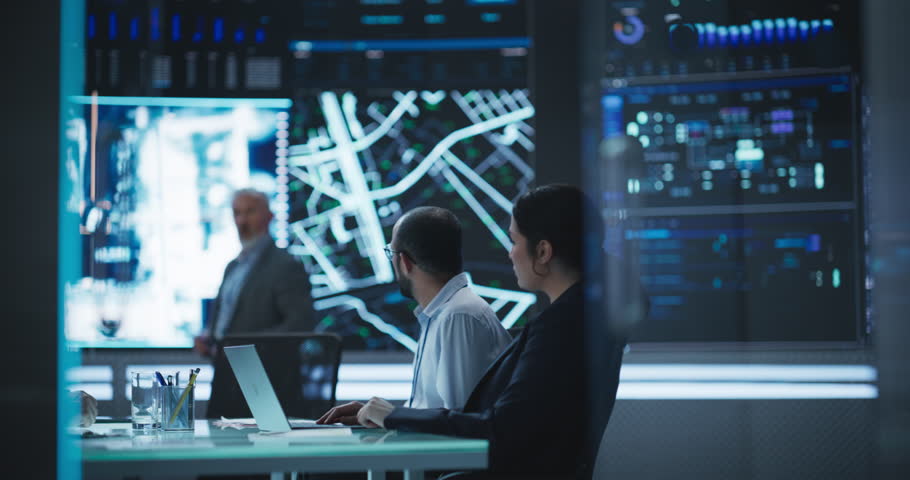 Senior Chief Software Engineer Showing a Satellite Tracking Technology Capabilities to a Group of High Profile Government and Cybersecurity Officials. Colleagues Discussing New GPS Software Royalty-Free Stock Footage #1104516863