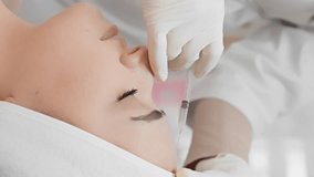 A well-deserved time for care, where a woman with an expression of calm on her face receives a beauty procedure through professional botulinum therapy at a cosmetologist, beauty clinic. Vertical video