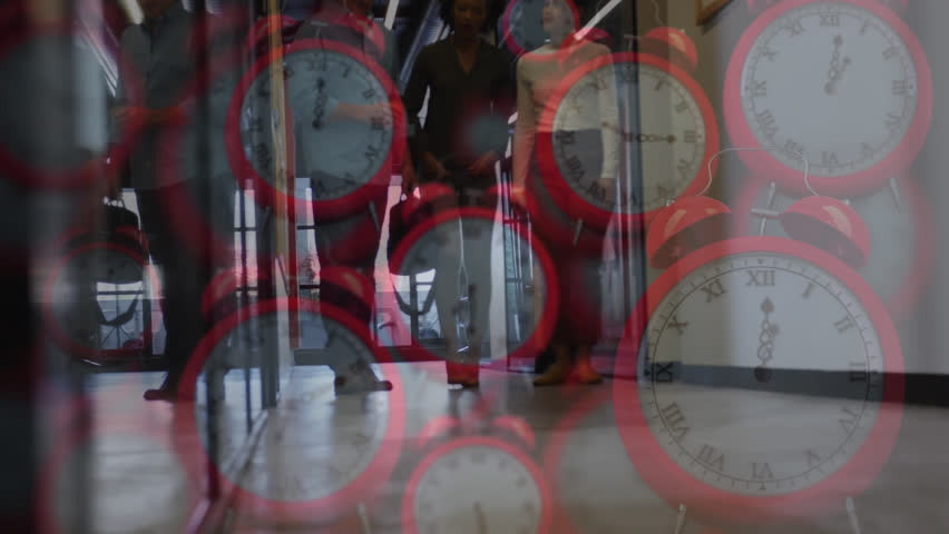 Animation of red alarm clock over diverse coworkers sharing ideas and walking in corridor of office. Digital composite, multiple exposure, time, alarm, teamwork, planning and technology concept. - Powered by Shutterstock - Get 15% off with code: PIKWIZARD15