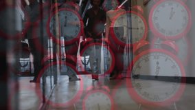 Animation of red alarm clock over diverse coworkers sharing ideas and walking in corridor of office. Digital composite, multiple exposure, time, alarm, teamwork, planning and technology concept. - Powered by Shutterstock - Get 15% off with code: PIKWIZARD15