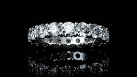 Diamond eternity ring swaying on black glossy background. Seamless loop 3d animation - Powered by Shutterstock - Get 15% off with code: PIKWIZARD15