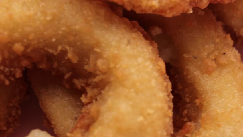 Onion Rings, rotation in circle. Fast food Turning, top view. selective focus.