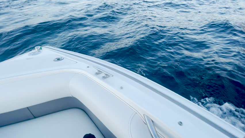 boat floats on water close-up. motor boat sails on blue water waves splash. boat trip on the sea canal water. water lifestyle sea vacation travel concept