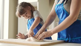 mother daughter preparing dough in kitchen. happy family cooking baking together. mother and bake small child preparing homemade cakes from flour and dough. happy family cooking at home - Powered by Shutterstock - Get 15% off with code: PIKWIZARD15