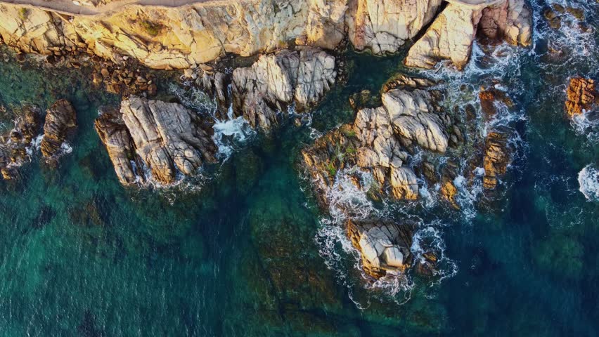 4K  Footage Aerial Top View Of Stones In Turquoise Sea Water Waves Wash The Rocks, Sandy Coast | Shutterstock HD Video #1104533543