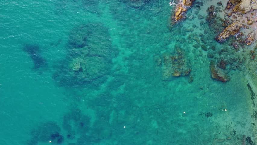 4K  Footage Aerial Top View Of Stones In Turquoise Sea Water Waves Wash The Rocks, Sandy Coast | Shutterstock HD Video #1104533545