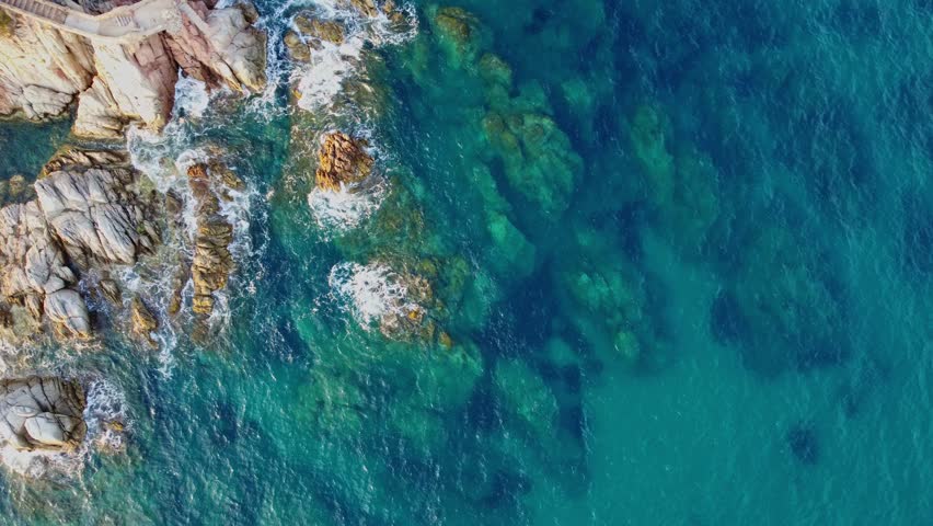 4K  Footage Aerial Top View Of Stones In Turquoise Sea Water Waves Wash The Rocks, Sandy Coast | Shutterstock HD Video #1104533549