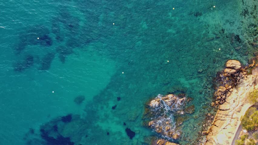 4K  Footage Aerial Top View Of Stones In Turquoise Sea Water Waves Wash The Rocks, Sandy Coast | Shutterstock HD Video #1104533553
