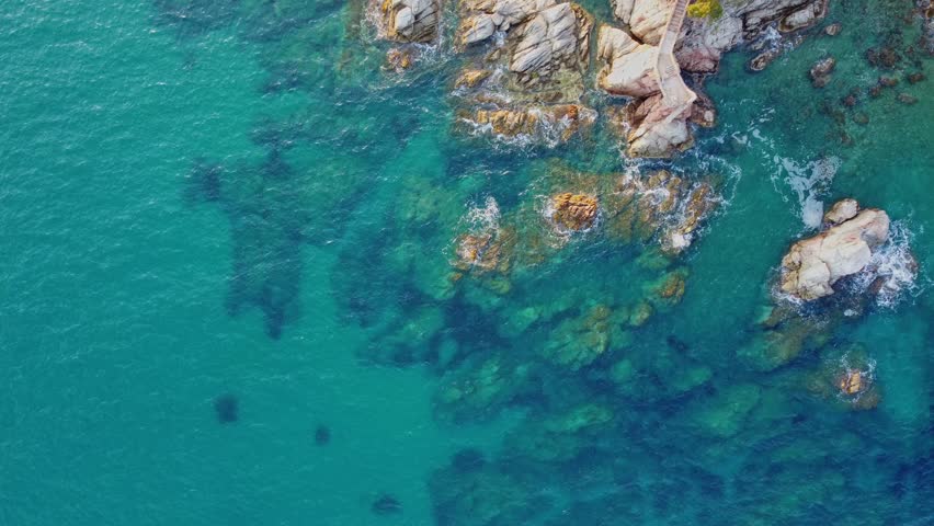 4K  Footage Aerial Top View Of Stones In Turquoise Sea Water Waves Wash The Rocks, Sandy Coast | Shutterstock HD Video #1104533555