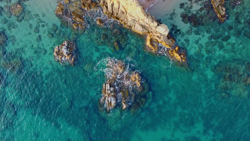 4K  Footage Aerial Top View Of Stones In Turquoise Sea Water Waves Wash The Rocks, Sandy Coast | Shutterstock HD Video #1104533557