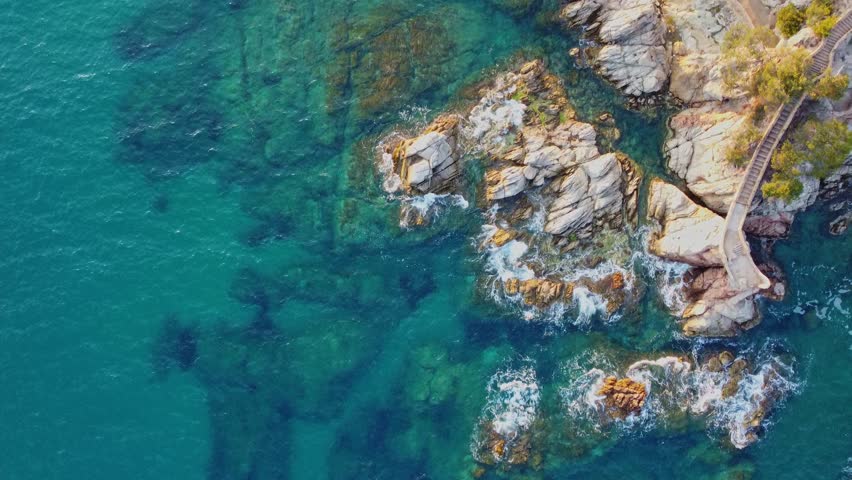 4K  Footage Aerial Top View Of Stones In Turquoise Sea Water Waves Wash The Rocks, Sandy Coast | Shutterstock HD Video #1104533559