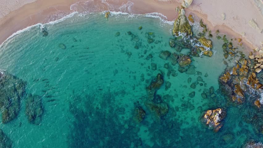4K  Footage Aerial Top View Of Stones In Turquoise Sea Water Waves Wash The Rocks, Sandy Coast | Shutterstock HD Video #1104533577