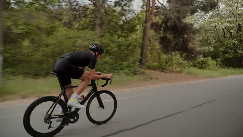 Triathlete Cyclist Training Bicycle. Sport Recreation Workout.Fit Athlete Sport Workout Training Cycling Triathlon Competition.Cyclist Fitness Cycling Road Bike Triathlon Race Cyclist Recreation Sport Royalty-Free Stock Footage #1104534405