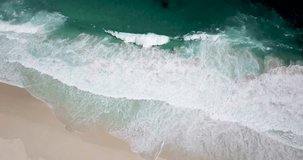 4K Aerial drone footage of Diaz Beach, Cape Town, South Africa. Turquoise clean water with white sand beach from above in Cape Peninsula. Huge waves. Cape Point Nature Reserve.