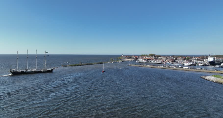 Large sailing ship entering the port of Urk to dock.