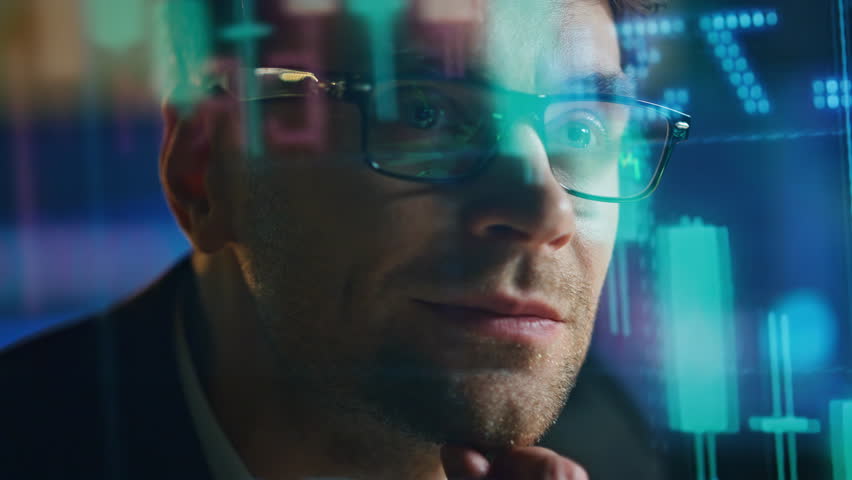 Closeup stock market analyst with economic holographic data. Smiling man trader thinking profit sales contemplating financial strategy. Professional investment manager checking hedge fund numbers. - Powered by Shutterstock - Get 15% off with code: PIKWIZARD15