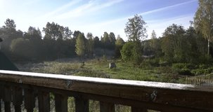4K autumn video of water mill wheel on sunny frosty morning in forest region