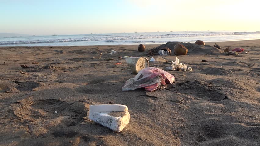 Plastic waste on the sandy beach of Pelabuhan Ratu, Indonesia Garbage pollutes the beach and scares away tourists. Plastic waste destroys coastal animal habitats. | Shutterstock HD Video #1104546253