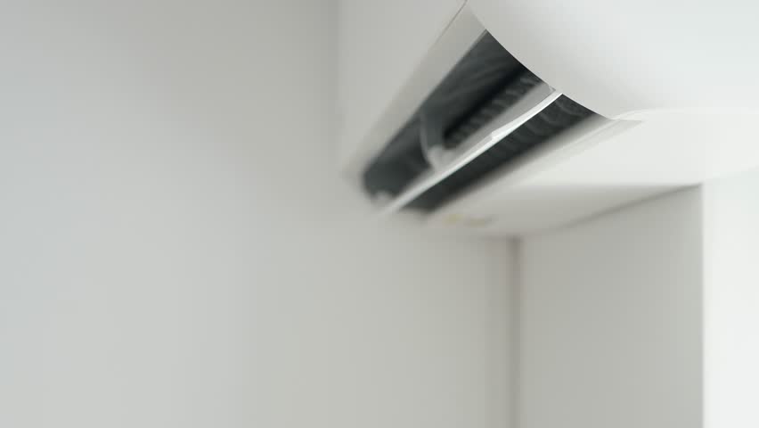 Air Conditioning Blowing Fresh Cool Air in the Office Changing the Room Temperature. Cooling Device Technology in Function. Split System. Shooting with an Air-Conditioner Working on a Hot Summer Day. Royalty-Free Stock Footage #1104552067