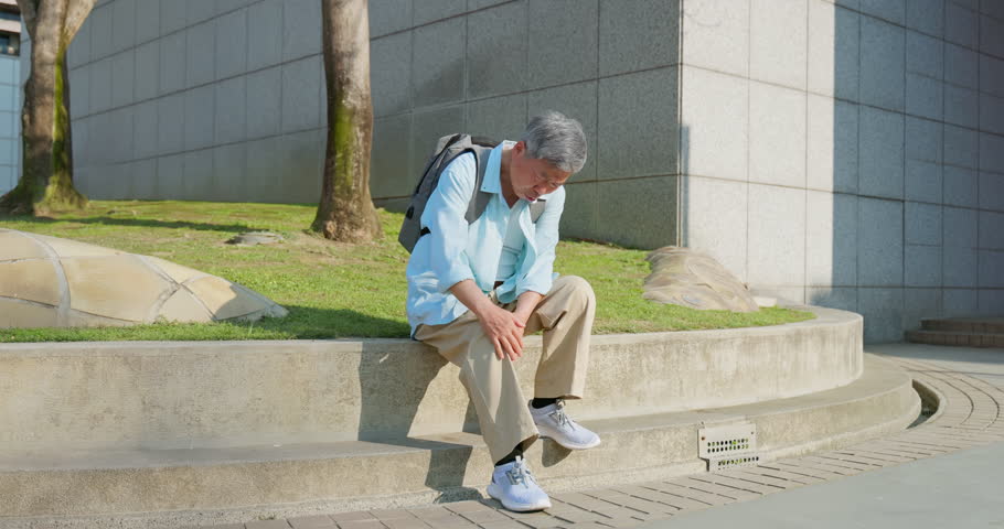 asian elderly person travel alone in the city - he got knees painful problem due to osteoarthritis disease unhealthy and worryable Royalty-Free Stock Footage #1104554033