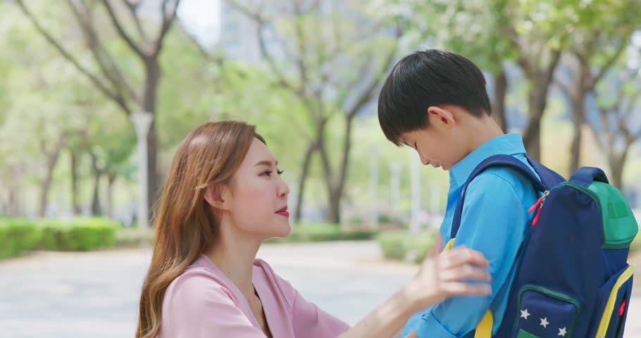 asian mother help the child grooming before going to school - with big hug showing her love closeness concern Royalty-Free Stock Footage #1104554065