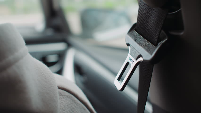 The hand reaches for the seat belt in the car Royalty-Free Stock Footage #1104555289
