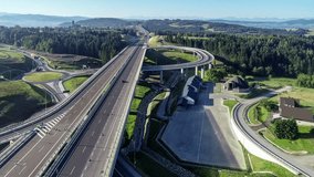 New highway in Poland on national road no 7, E77, called Zakopianka.  Overpass crossroad with a traffic circle, slip roads and viaducts near Skomielna Biala. Aerial video. Far view of Tatra Mountains