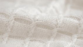texture of crumpled knitted woolen clothes with pattern of natural wool closeup. rotation. soft knitted wool fabric in white. cozy woolen fabric, knitwear, warm sweater. macro. - Powered by Shutterstock - Get 15% off with code: PIKWIZARD15