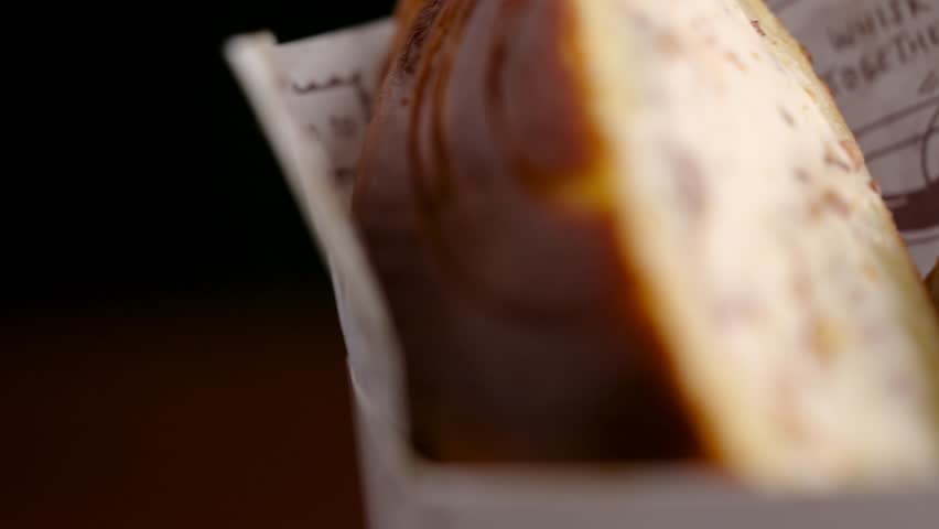 A delightful combination of ice cream and toasted bread forms a scrumptious sandwich. The creamy and cold ice cream melts into the warm and crispy bread, creating a mouthwatering treat.