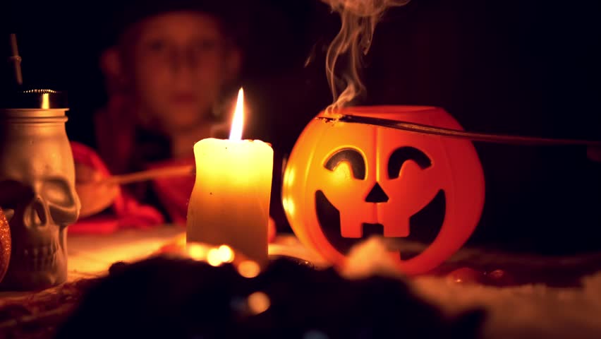 Jack-o-lantern close up lighted candles, Happy children boys in carnival costumes with attributes of Halloween blow out candles on background. Happy kids, vampire, jack o lantern. Autumn, October | Shutterstock HD Video #1104570331