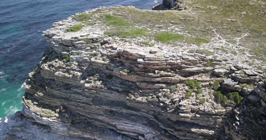4K Aerial drone footage of Diaz Beach, Cape Town, South Africa. Rocky cliffs and Turquoise clean water with white sand beach in Cape Peninsula. Cape Point Nature Reserve with specific fauna and flora