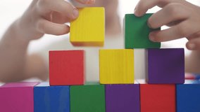 child girl in kindergarten play with blocks on table by the window. fun education development children game concept. child kid play with blocks at home rejoice having. child play cube at home - Powered by Shutterstock - Get 15% off with code: PIKWIZARD15