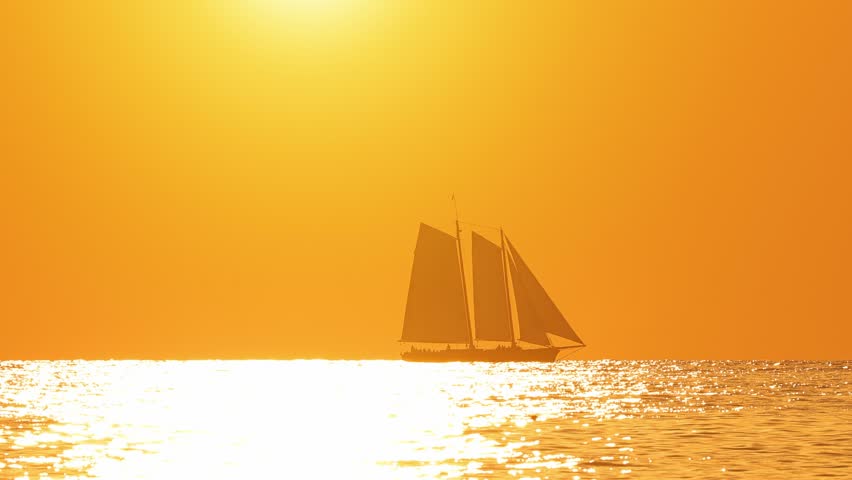 The setting sun and a sail boat in Key West Florida