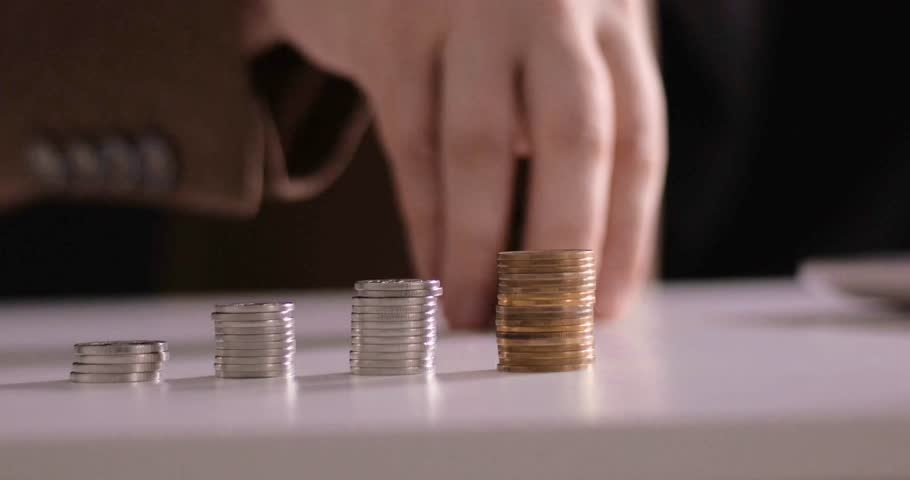 Businessman's hand moves stacks of money. Business finance and investment concept, world capital gains, money economic growth. financial graph of stack of coins, market report on cash currency concept Royalty-Free Stock Footage #1104576617