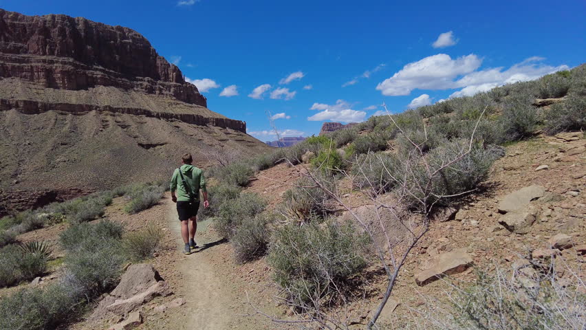 Following Hiker Along Tonto Trail in the Grand Canyon