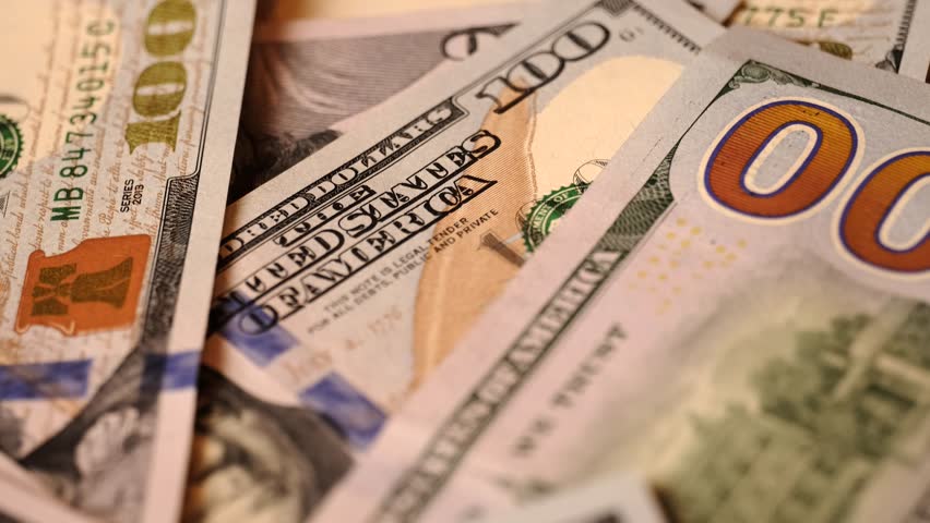  Us national paper currency. Hundred dollar bill close-up the camera moves from bottom to top. American one hundred dollar banknotes. 100 dollar bills close up tracking.