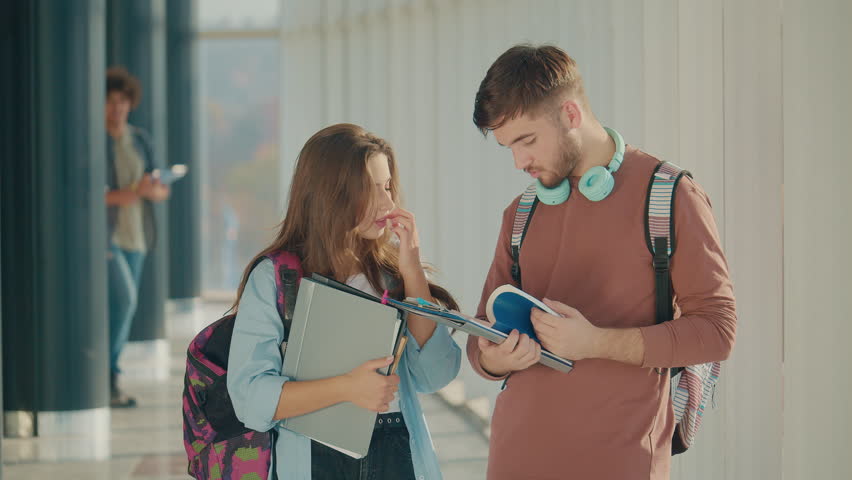 Two Attractive Students Talk at High School College Hall. Young Leaders. Cultural Diversity in Education and Society Royalty-Free Stock Footage #1104582891