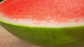 Macro video of watermelon with probe lens reveals its vibrant red flesh, dotted with black seeds. The lens captures intricate details, showcasing the fruit's refreshing. Macro dolly shot. 4K HDR
