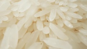 Macro Textures: Up-close and personal, the macro video captures the intricate textures of jasmine rice as it pours onto the floor, revealing the beauty found within each individual grain. 4K
