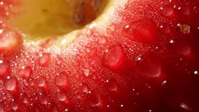 Water droplets on red apple in macro video, The probe lens, known for its unique and extreme close-up capabilities, Witness the minute intricacies that go unnoticed in everyday observation. 4K HDR
